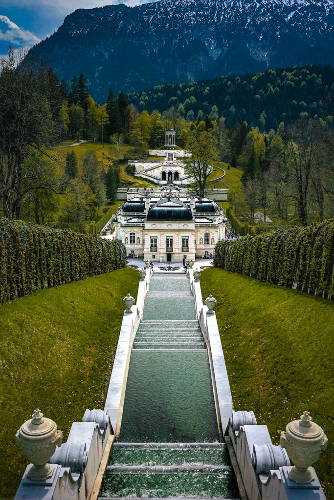 Stunning scenic view of Linderhof Palace and gardens nestled in the Bavarian mountains.